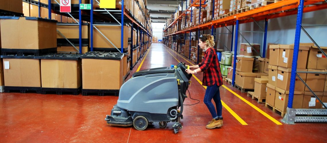 woman doing cleaning in warehouse